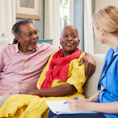 senior couple talking to a medical worker