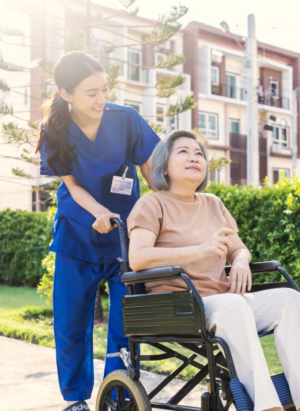 healthcare worker and senior woman outdoors