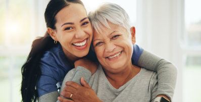 nurse and senior patient hug in elderly care