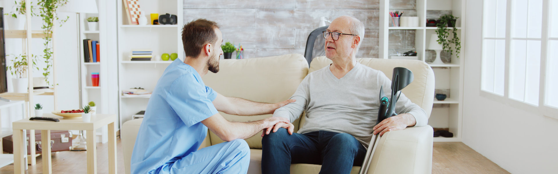 healthcare worker and senior man talking